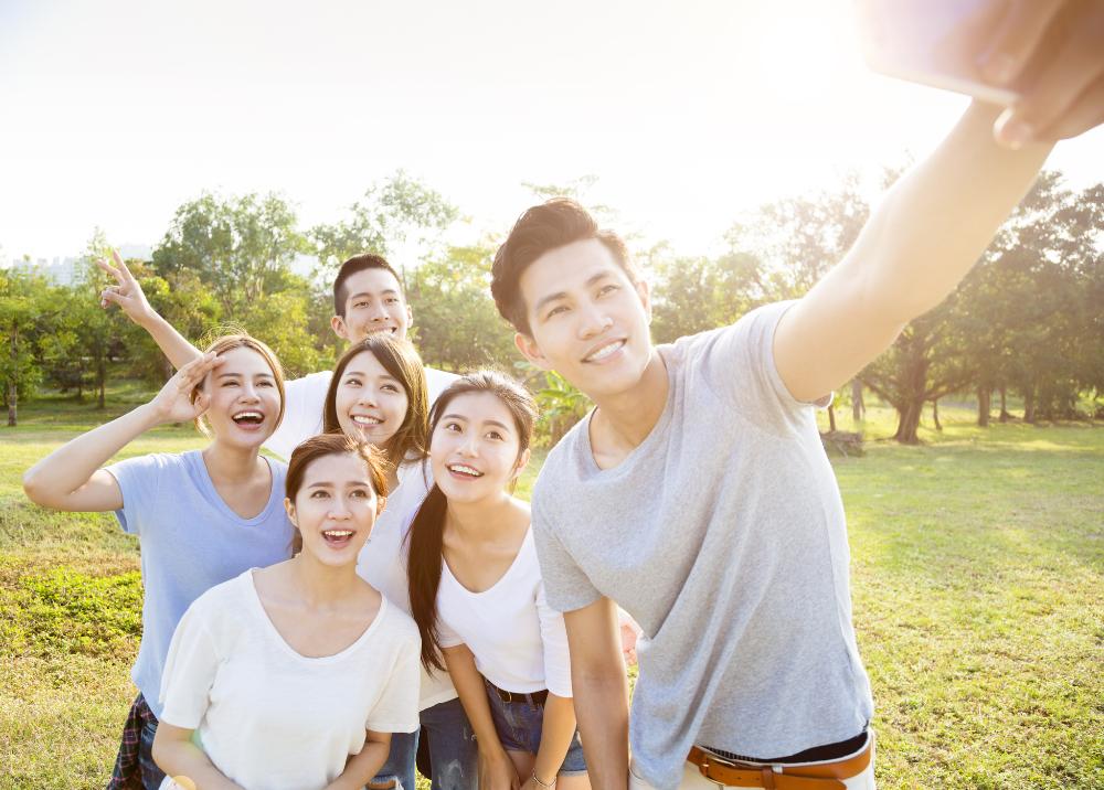 teenagers taking selfie in park.jpg