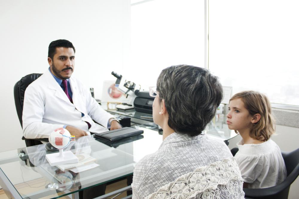 Man eye doctor talking to parent.jpg