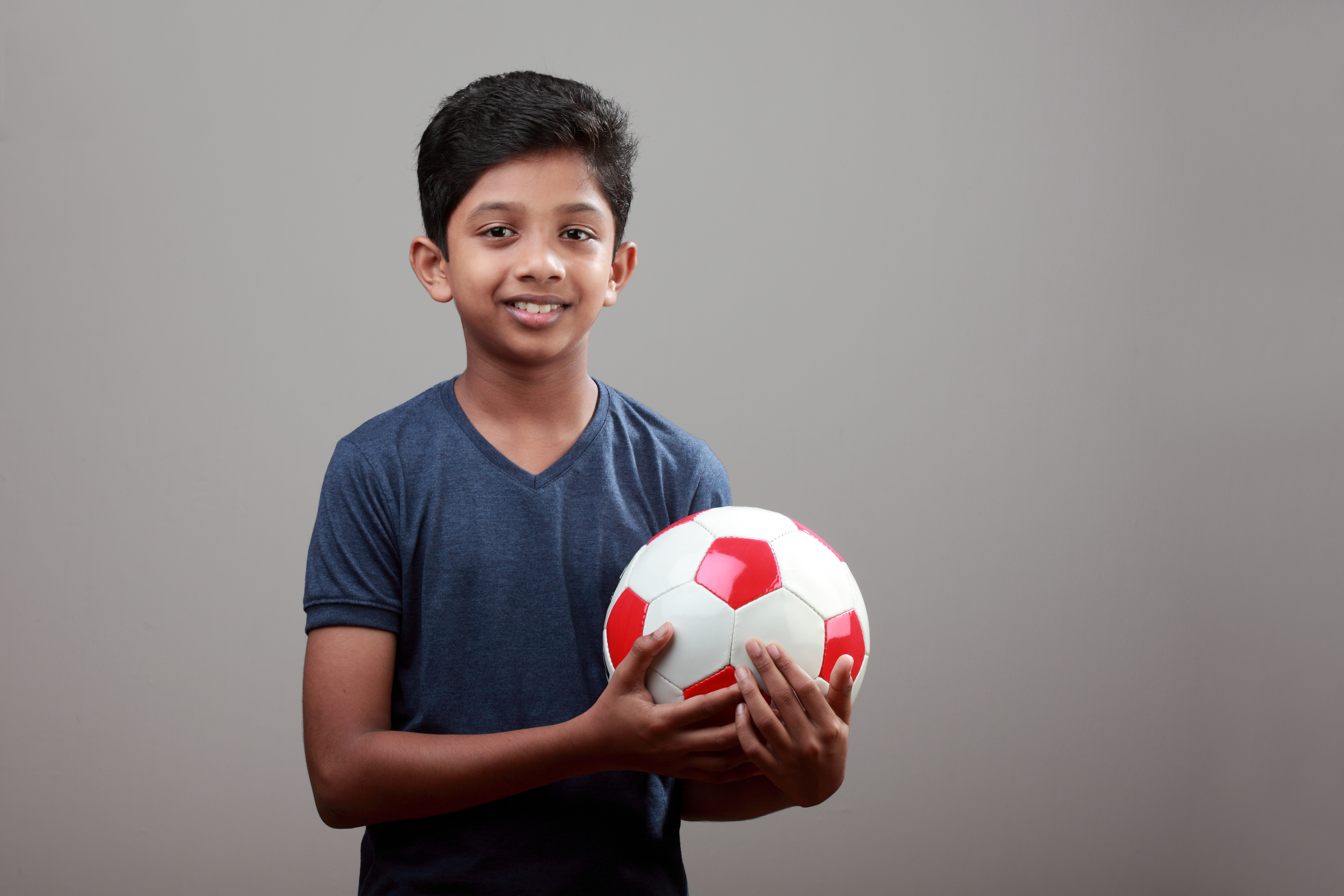 South Asian boy with ball_Clinical Leader Case Study Transitioning from soft contact lenses to Orthokeratology.jpg