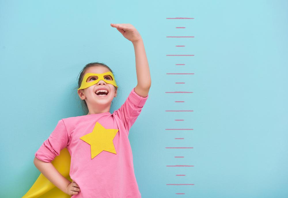 Girl getting taller wearing superhero cape_When you have low myopia and high axial length.jpg
