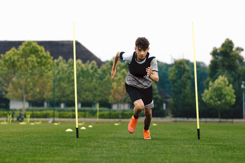 teenage boy running cleats.jpg